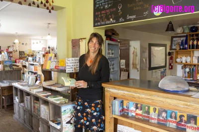 Karine Depeyre au Kairn, entre l'espace librairie et le comptoir du bistrot/ Stéphane Boularand (c)Bigorre.org
